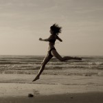Athletic woman running on the beach